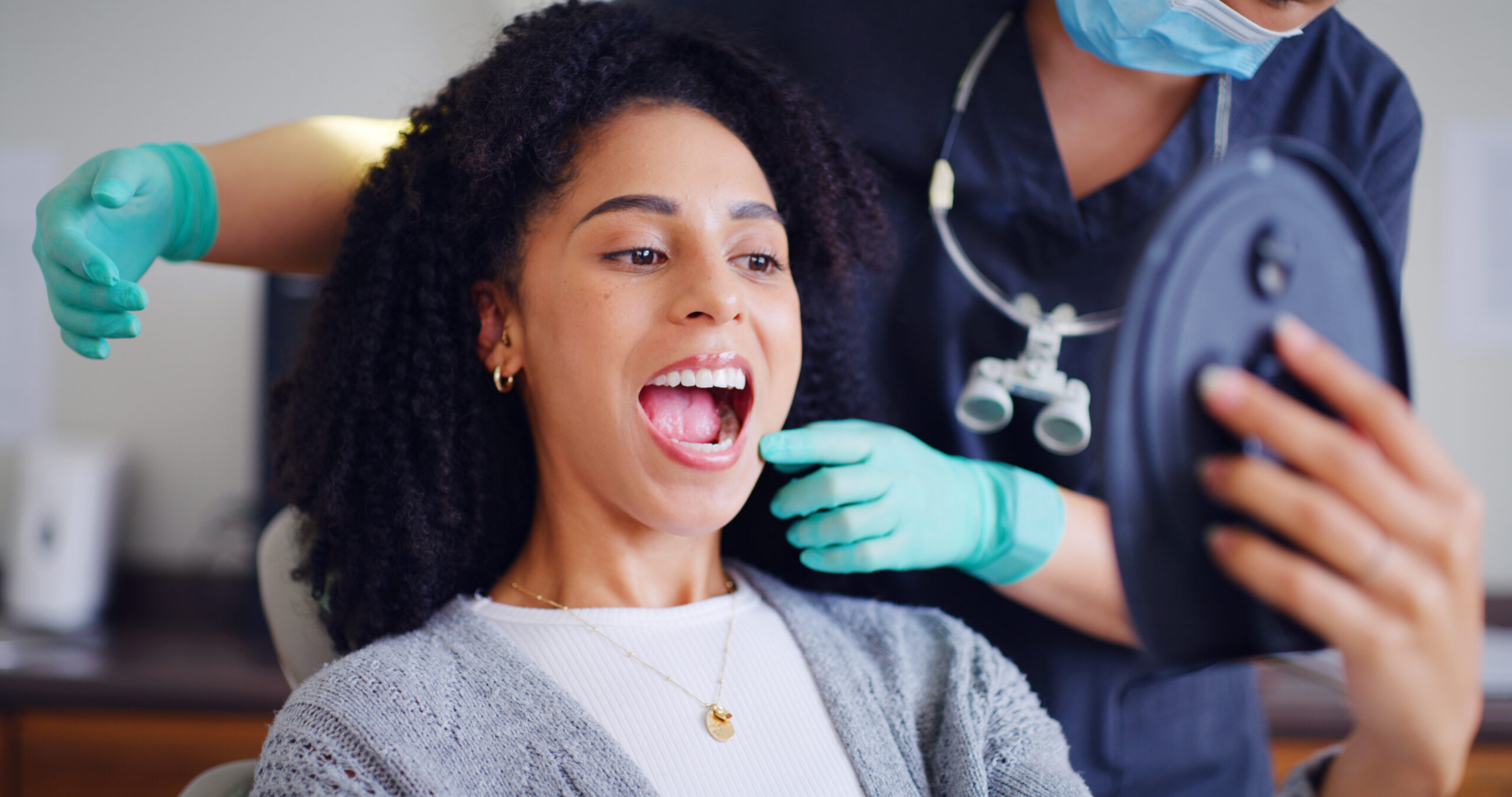 Woman, teeth and mirror for checkup with dentist, oral hygiene and mouth cleaning service. Female person, assessment and orthodontic inspection for dental care, patient and help for consultation.