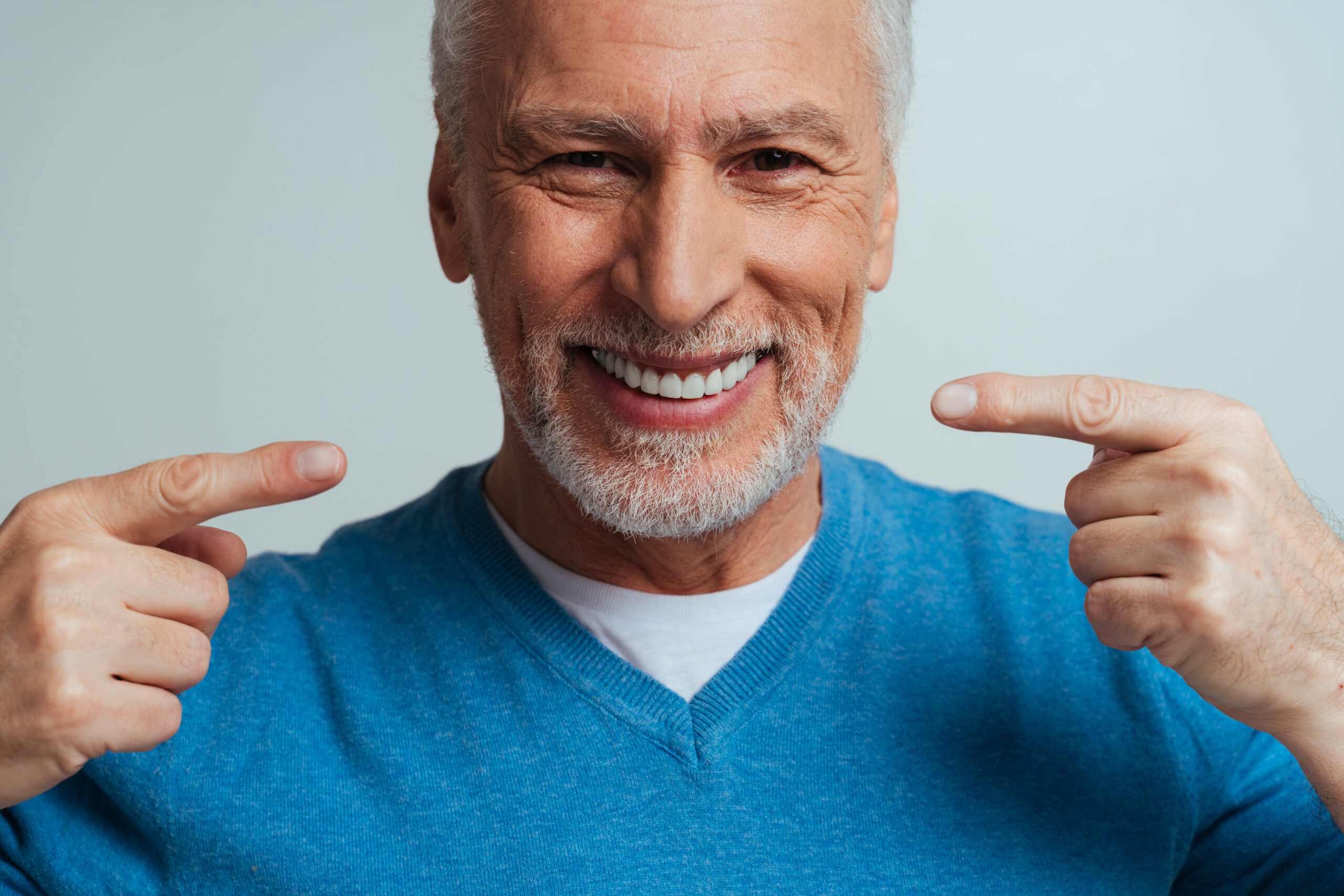 Handsome senior isolated on grey background. Concept about the third age and seniority