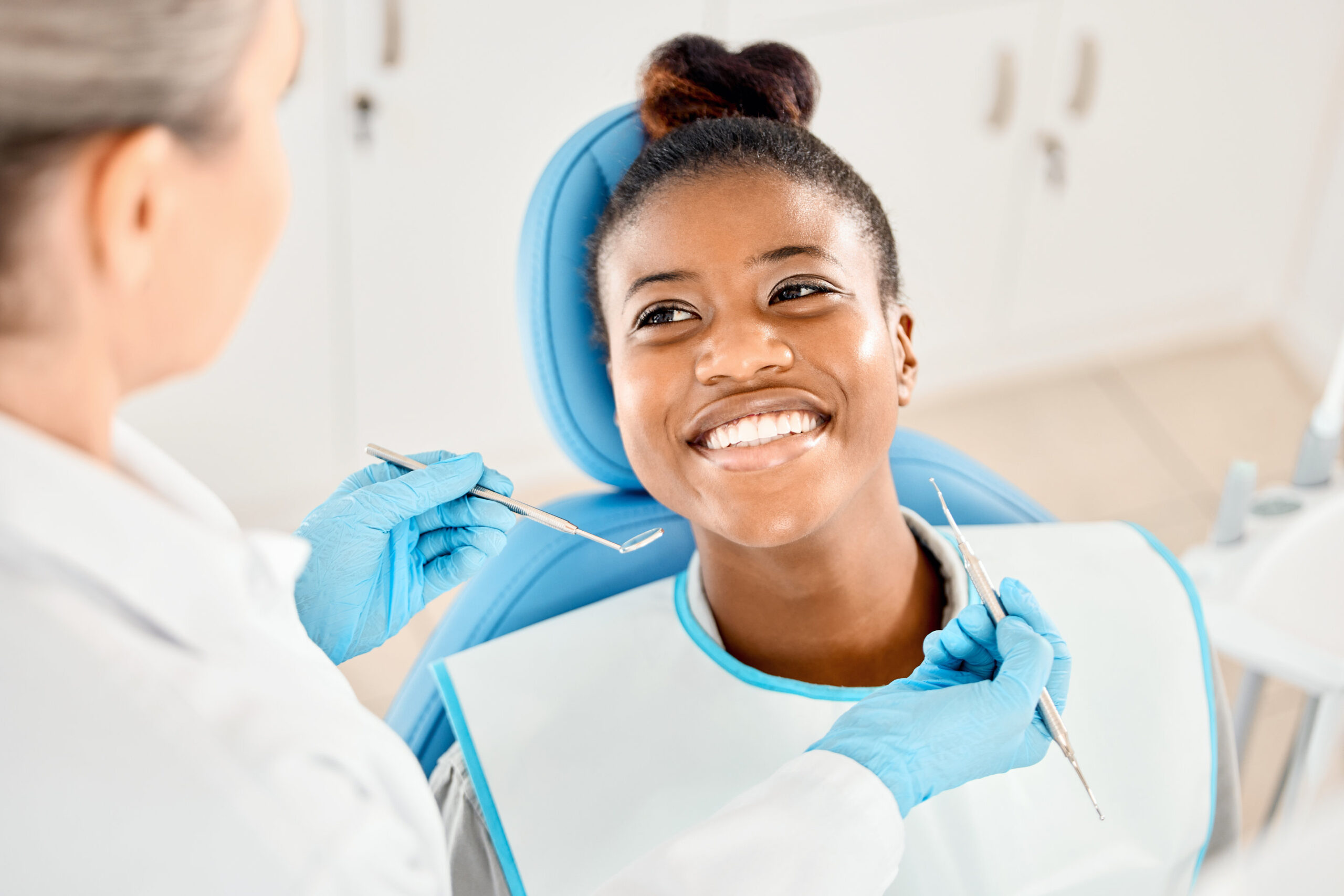 Mirror, smile and woman with tools, dentist and happy for oral health, healthcare and dental hygiene. Teeth, mouth and results for wellness of person, specialist and exam for treatment of patient.